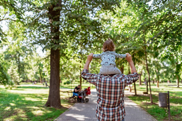 istock Father carrying son on shoulders 1150800975
