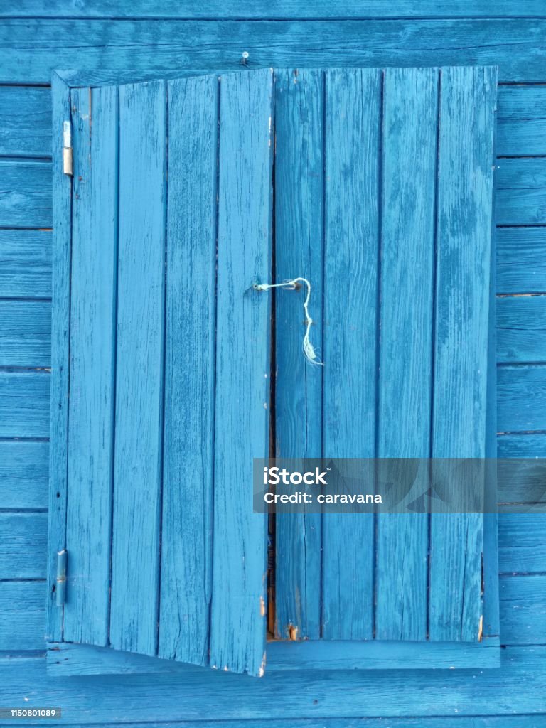 Closed blue window. Fisherman house closed blue window. Abstract Stock Photo