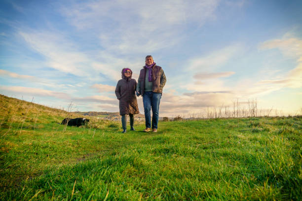 istock Senior couple walking on countryside path in winter 1150802371