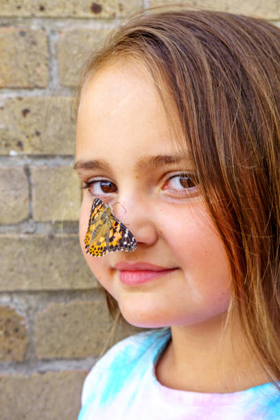istock Ten year old girl with butterfly on her nose 1150802437
