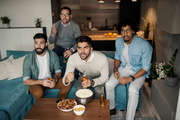istock Friends watching sport on tv. 1150803894