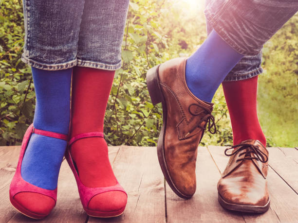 istock Men's and women's legs, bright socks. Close-up 1150804130