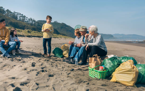 istock Volunteers resting after cleaning the beach 1150805326