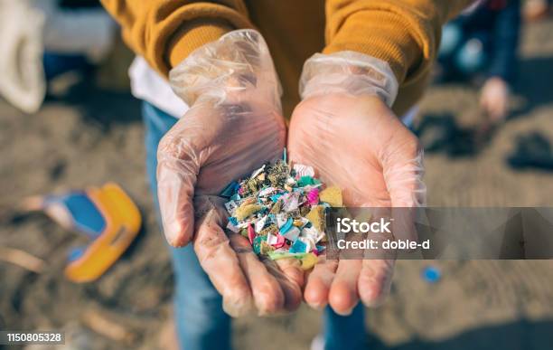 Hands With Microplastics On The Beach Stock Photo - Download Image Now - Microplastic, Plastic, Beach