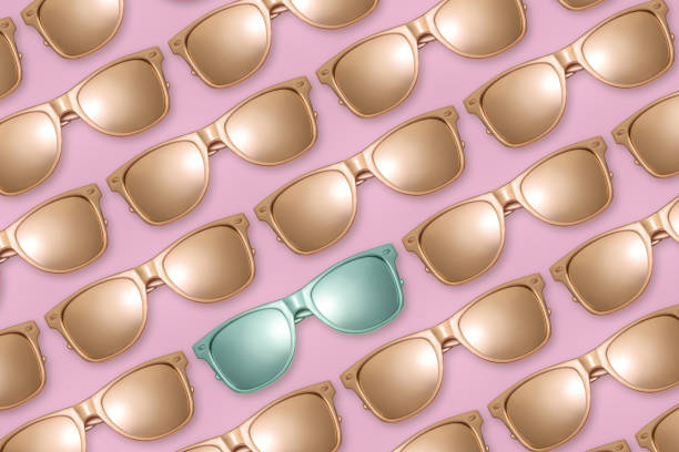 istock Pattern of golden sunglasses on pink background. 1150806236