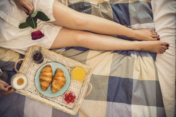 istock Beautiful young girl having breakfast in bed 1150808022