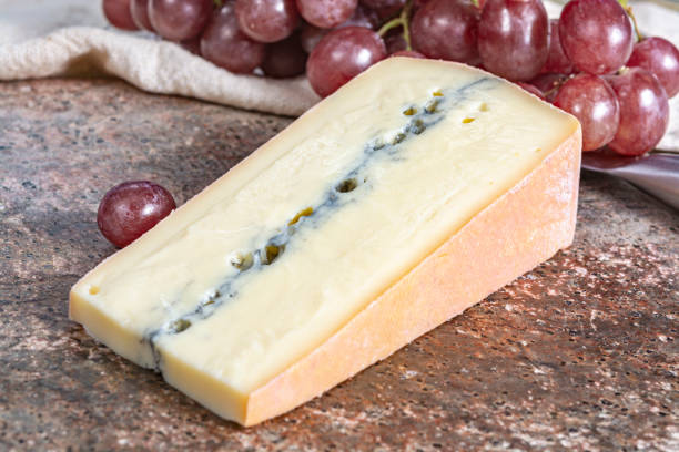 morbier semi-soft cow milk french cheese with black mold layer - morbier imagens e fotografias de stock
