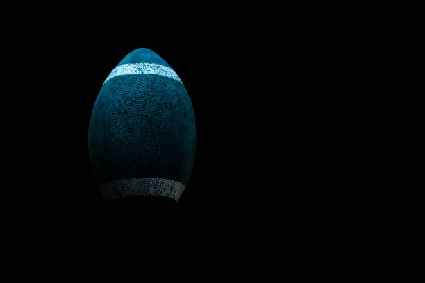 istock Old rugby ball isolated on black background. 1150812354