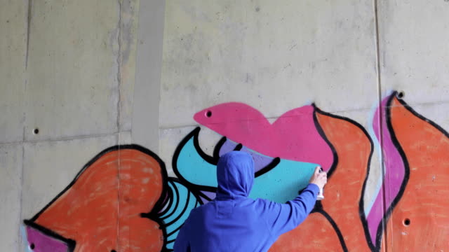 Graffiti Artist Spraying Graffiti on Wall