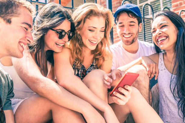 istock Happy multiracial friends having fun with a smartphone 1150814631