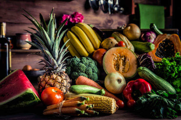 istock Assorted tropical fruits and vegetables in a rustic kitchen. Natural lighting 1150818639