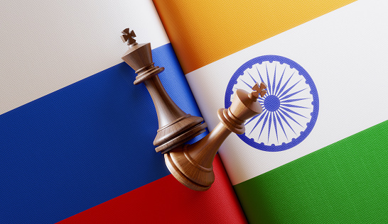 Russian and Indian  flag pair with king chess pieces. Horizontal composition with copy space and selective focus.