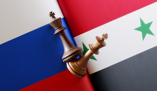 Russian and Syrian flag pair with king chess pieces. Horizontal composition with copy space and selective focus.