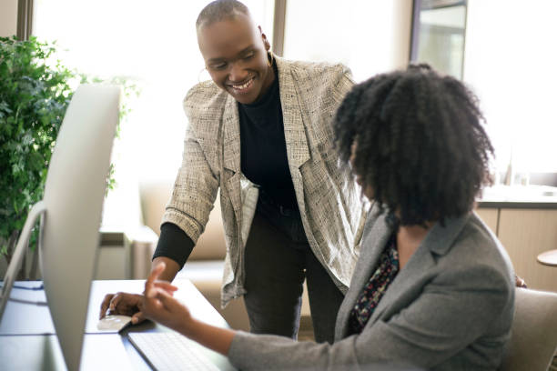 istock Black Female Office Coworkers Doing Teamwork 1150829350