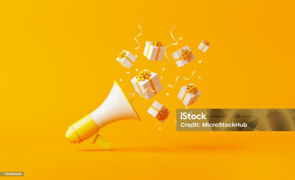 Gift Boxes Coming Out of A Yellow Megaphone over Yellow Background Gift boxes coming out of a yellow megaphone over yellow background. Horizontal composition with copy space. Great use for announcement concepts. Gift Stock Photo