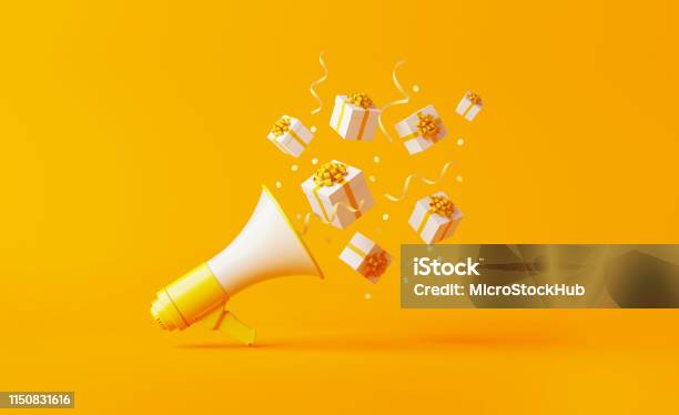 Gift Boxes Coming Out Of A Yellow Megaphone Over Yellow Background Stock Photo - Download Image Now