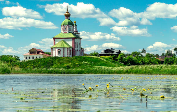 Beautiful old church near the lake under the blue summer sky stock photo