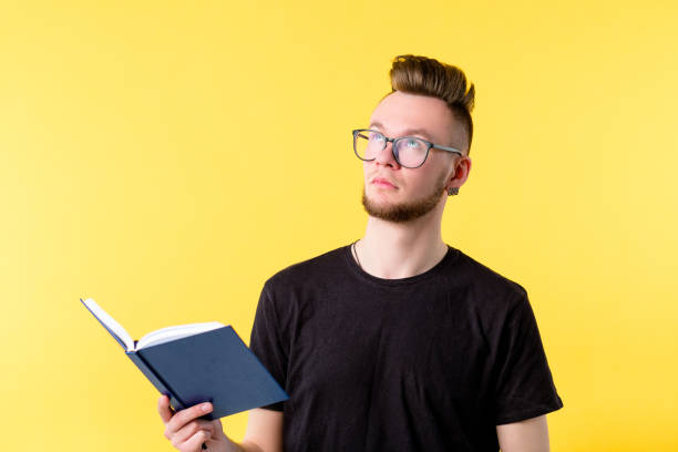 istock young man book looking up contemplation expression 1150835128