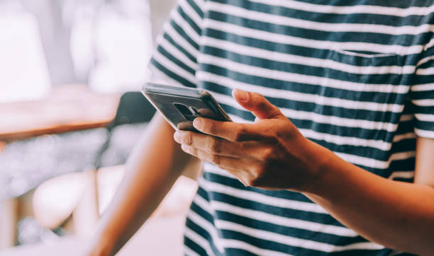 istock Young man using mobile phone in coffee shop 1150838590