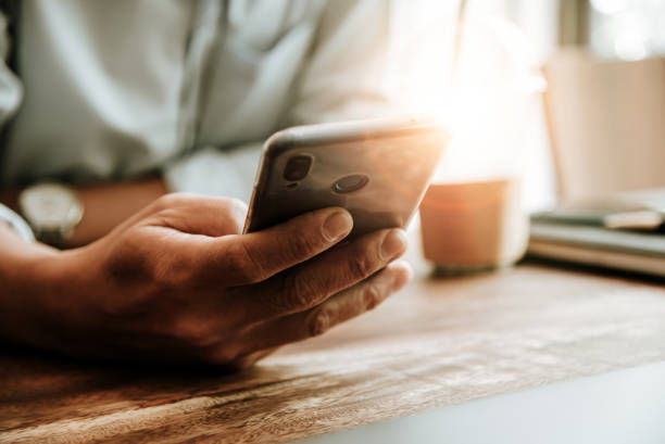 istock Man using smart phone mobile for connect with friends in coffee shop 1150838771