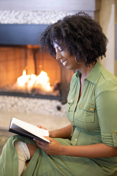 istock Black Female Reading a Book at Home 1150847544