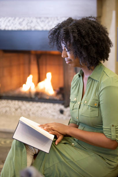 istock Black Female Reading a Book at Home 1150847582