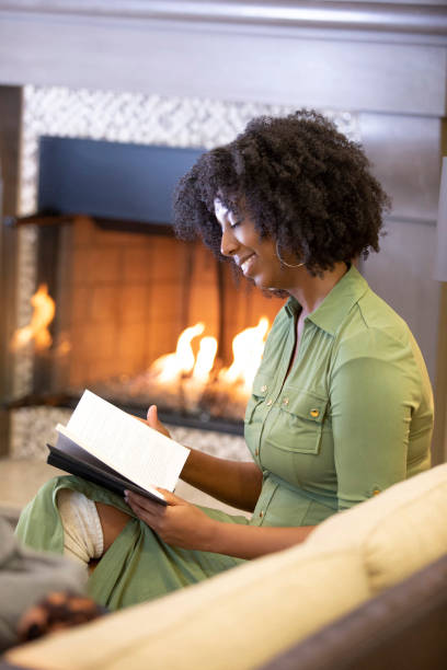 istock Black Female Reading a Book at Home 1150847588