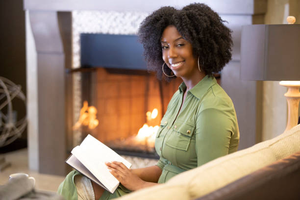 istock Black Female Reading a Book at Home 1150847605
