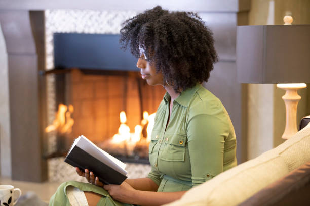 istock Black Female Reading a Book at Home 1150847609