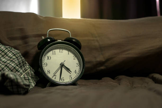istock Vintage alarm clock on vintage bed 1150849700