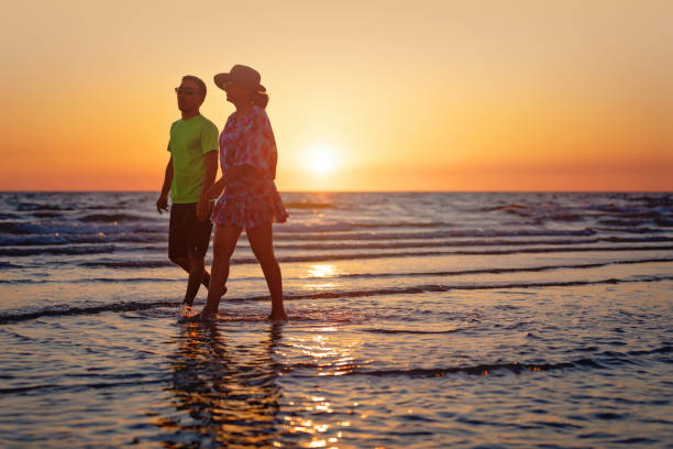istock Mother and son walking on a Florida beach 1150850303