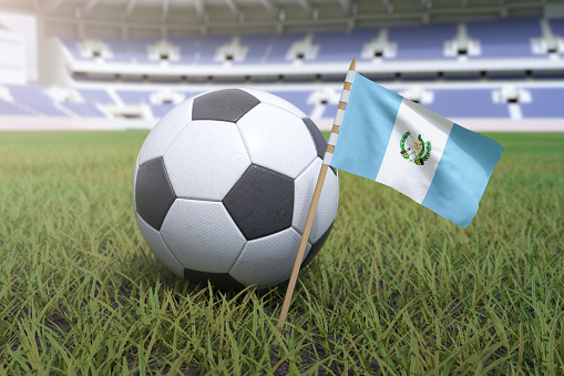 Guatemalan flag in stadium field with soccer football