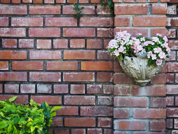 White vintage flowerpot roman style hanging on old brick wall background with copy space.