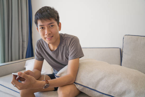 istock Young business Asian men using digital tablet and smart phone do their work at home and relax with online shopping in his vocations 1150851699