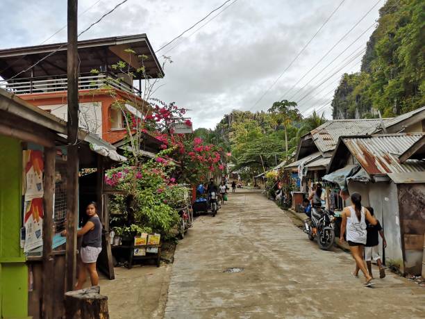 People on the street in El Nido village, Palawan, Philippines. It is known for its white-sand beaches, coral reefs, limestone cliffs and as the gateway to the Bacuit archipelago.