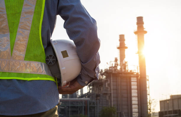 istock engineering man with white safety helmet standing in front of oil refinery building structure in heavy petrochemical industry 1150858259
