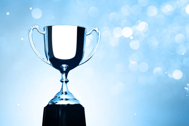 istock Silver Trophy competition award on the abstract blurred light background 1150858512