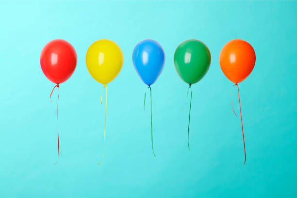 istock Five colorful balloons in mid-air against blue background 1150859723