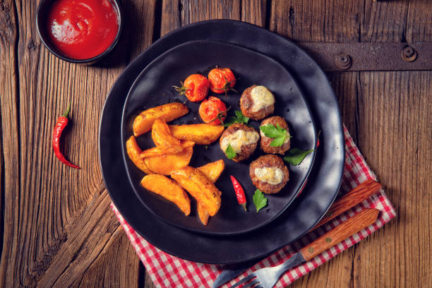 istock Meatballs with potato quarter from the oven 1150863135