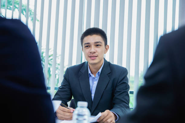 istock asian businessman candidate presenting his profile application on job interview 1150865176