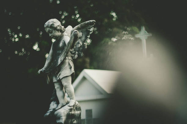 istock Cemetery Statues tomb Cross Lapide 1150866007