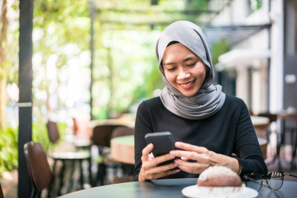 istock Young Malaysian woman using a smartphone 1150867256
