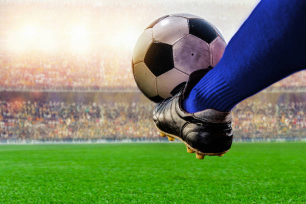 istock blue soccer player kicking ball action in the stadium 1150867864
