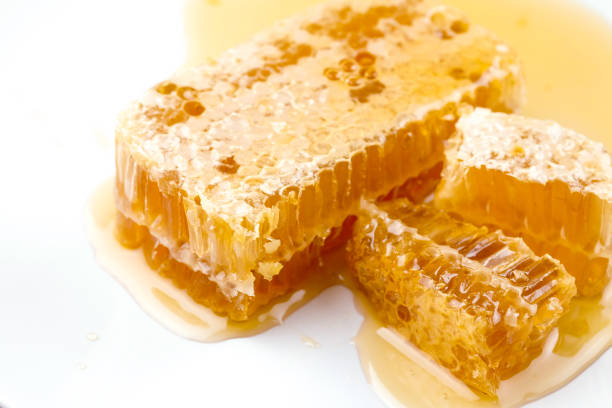 istock Honeycomb dipper and honey on white plate 1150868259