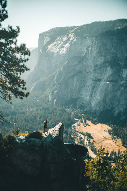 istock Female hiker relaxes over valley in mountains 1150873922