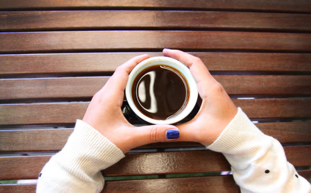 istock Coffee cup on a wooden table background 1150875586