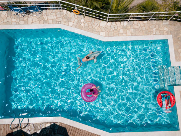 istock Two boys on inflatable floats in the swimming pool 1150877765