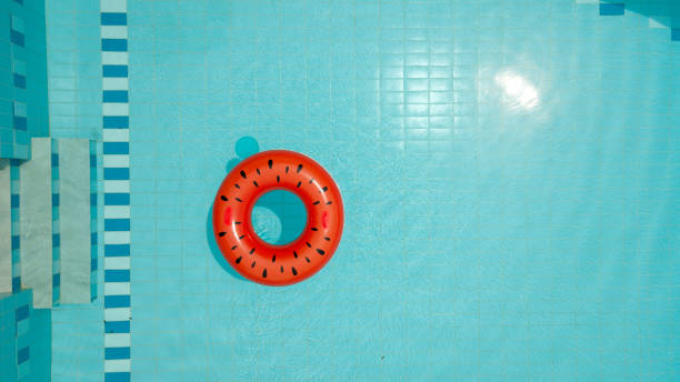 istock Inflatable ring with watermelon print floating on water in the pool 1150877769