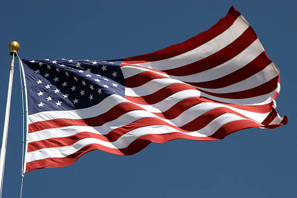 United States U.S. Flag flag pole and United States flag waving stock pictures, royalty-free photos & images