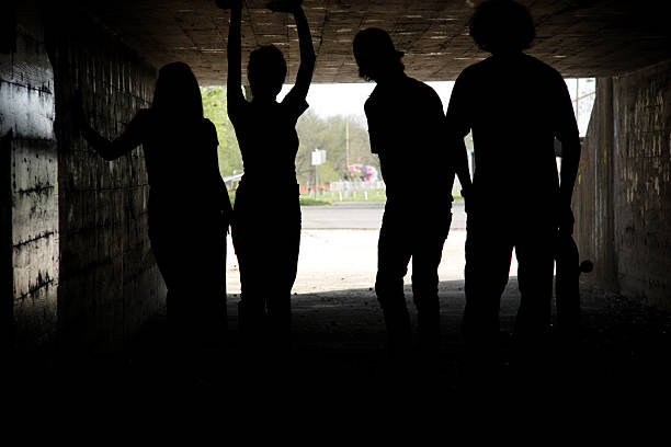 istock teens in tunnel silhouette portrait 115088360